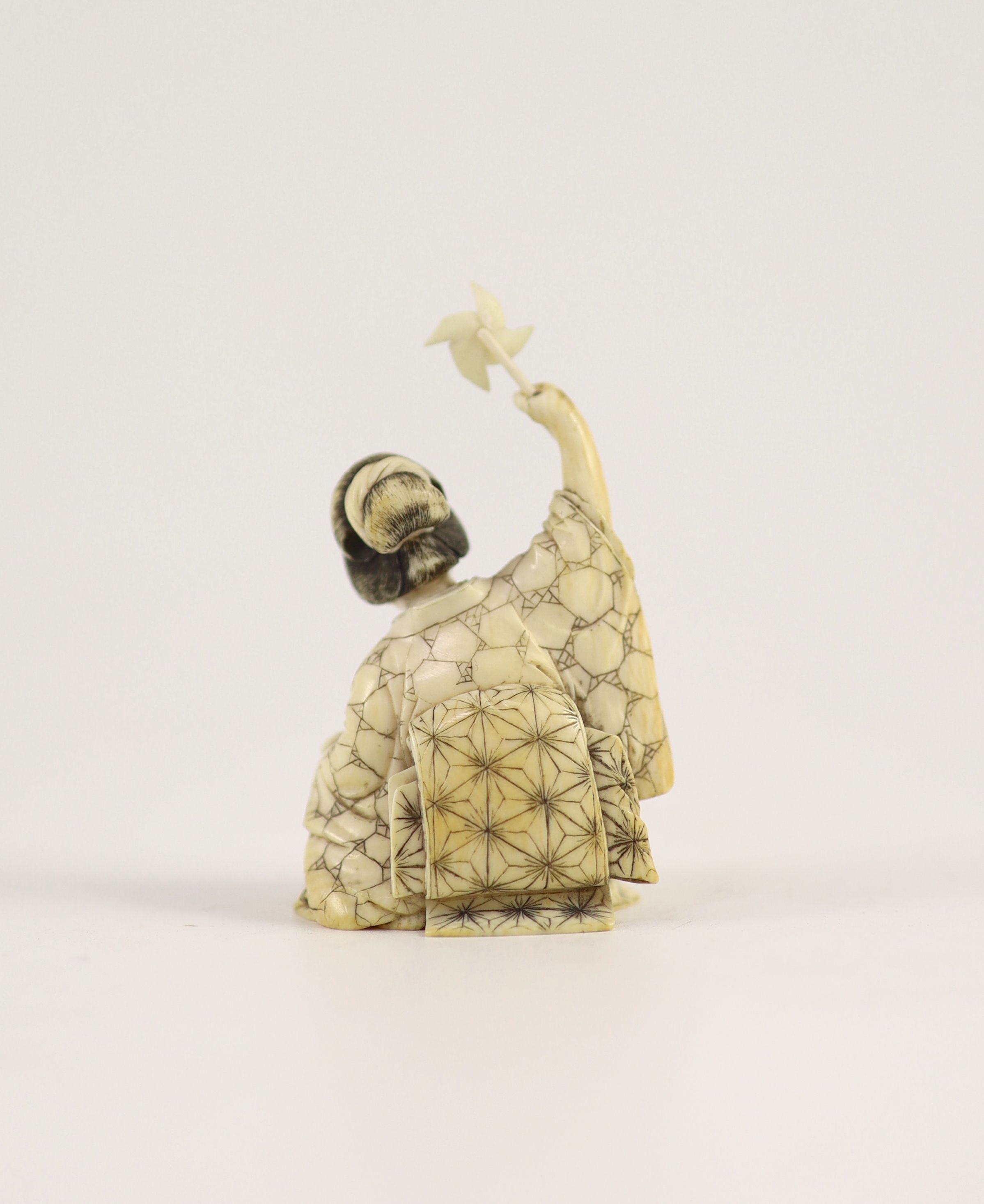 A Japanese ivory okimono of a mother and child, Meiji period, 6.4 cm high